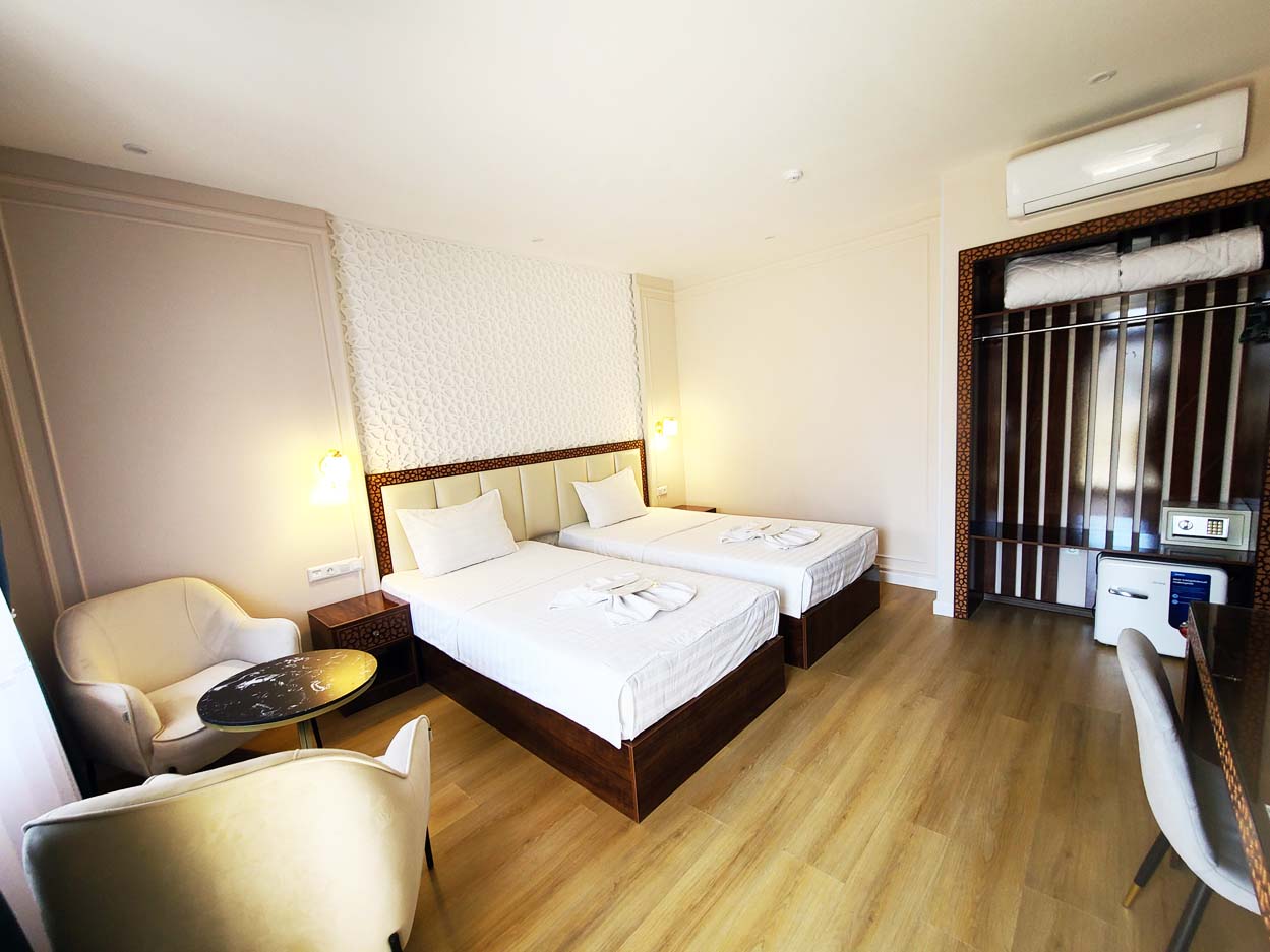 Charming deluxe double room in the hotel, featuring a comfortable double bed, desk, and wardrobe
