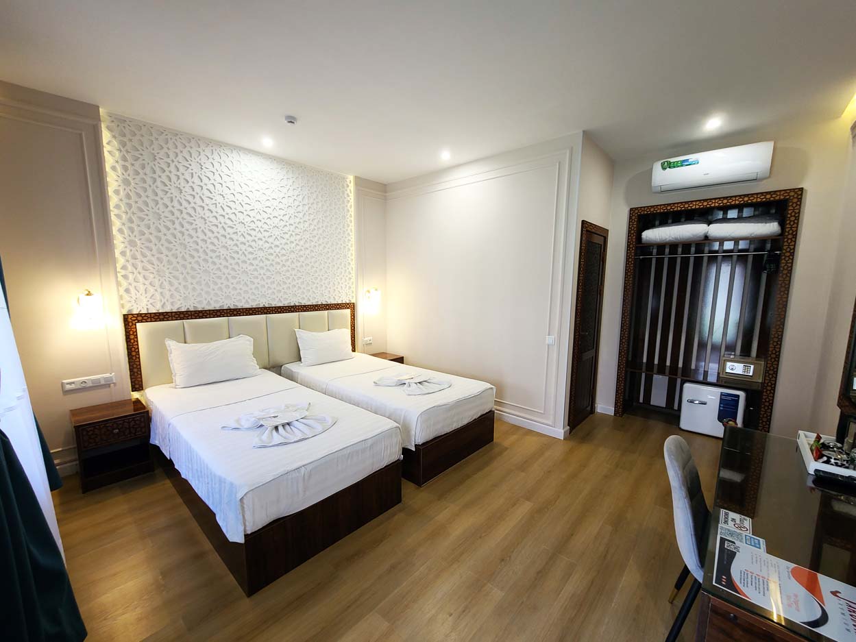 Spacious hotel accommodation with double bed, desk, and wardrob